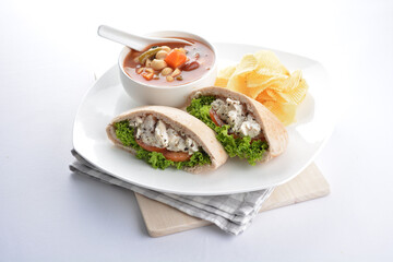 chicken tuna salad kebab open pocket bread with tomato abc soup and crispy potato chips combo healthy set in plate on white background asian halal food cuisine vegan menu for cafe design