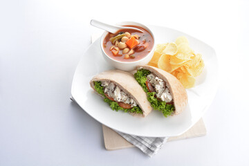 chicken tuna salad kebab open pocket bread with tomato abc soup and crispy potato chips combo healthy set in plate on white background asian halal food cuisine vegan menu for cafe design