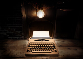 writting story on old paper from classic typewriter on old wood and brickwork underground room in...