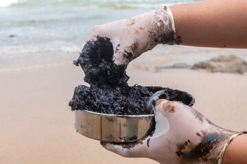 Tarballs are lumps of dark sticky oil paint environmental pollution..sea