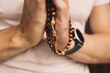 close-up of a Catholic praying with the rosary
