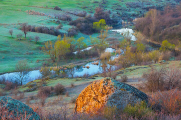 small river flow through prairie canyon