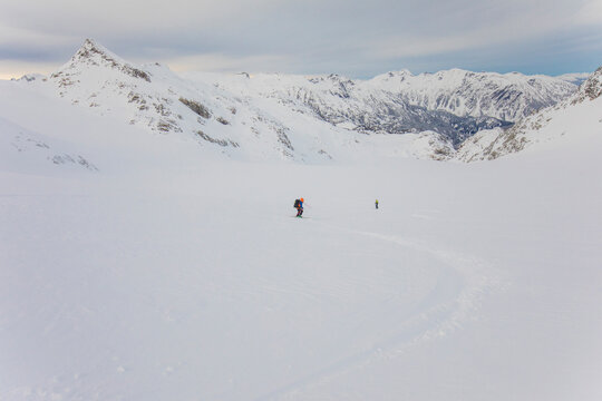 Distant view of people skiing with mountain view, B.C. Canada