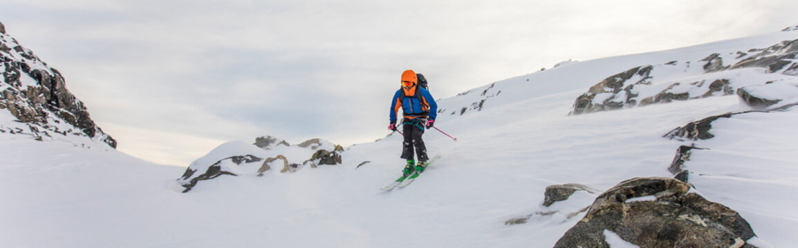 Skier tucks in to get more speed heading downhill.