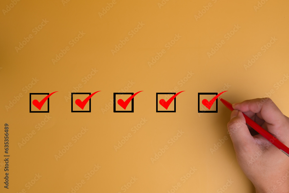 Poster hand using pen checklist concept, check mark on yellow background with copy space