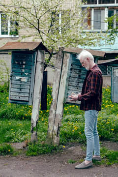 Albino man checking his letters near the blue mailbox