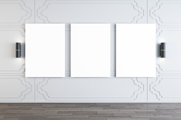 Modern gallery interior with empty white mock up frames on decorative wall, lamps and wooden flooring. 3D Rendering.