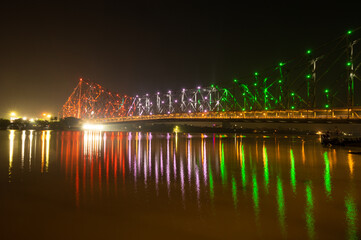 Howrah bridge - The historic cantilever bridge on the river Hooghly lit with tricolor of India on the occasion of Independence day of India. Howrah bridge is considered as the busiest bridge in India.