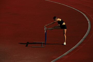 Athlete training on running track.