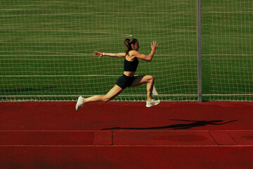 Athlete training on running track.