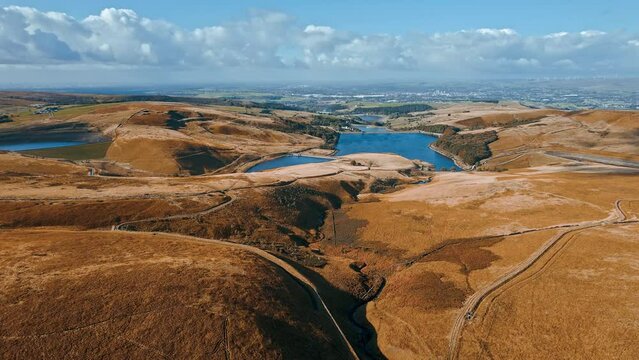 Aerial drone, cinematic footage of a valley with 3 lakes reservoirs, piethorn, kittcliffe and ogden reservoir, Oldham, UK
