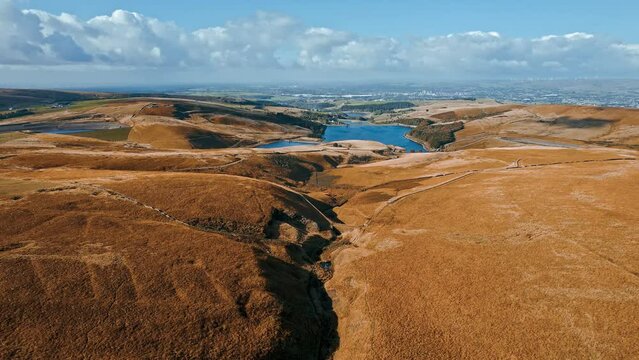 Aerial drone, cinematic footage of a valley with 3 lakes reservoirs, piethorn, kittcliffe and ogden reservoir, Oldham, UK