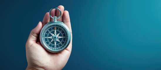 Composite image of a hand holding a compass on a blue background depicting strategic orientation in business or marketing - obrazy, fototapety, plakaty