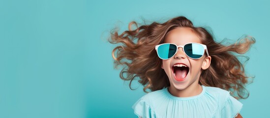 Funny preteen girl with serious expression promotes children s product on blue background