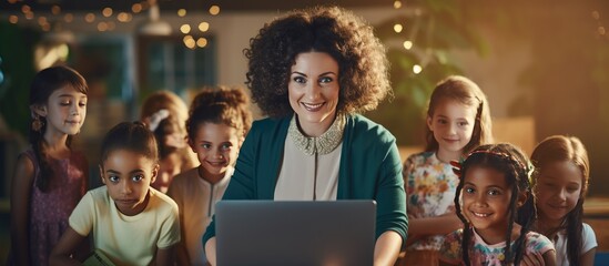 A varied female teacher using a laptop with young schoolgirls in a classroom space for text School learn childhood communicate and educate unchanged