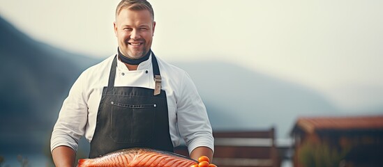 Man grilling salmon fish outdoors empty area Man barbecuing salmon in apron