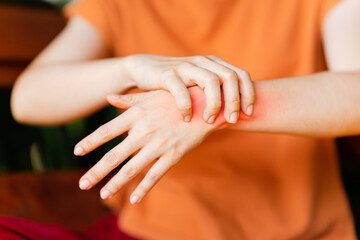 Woman with wrist pain due to arthritis or caused by office work. Concept of health problems.