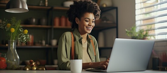 Happy Middle Eastern woman smiling while making a video call and enjoying online communication in the kitchen with space for text