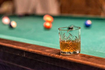glass of Rum on a billiard table