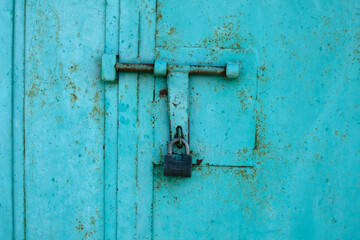 Padlock on metall door. Metal background