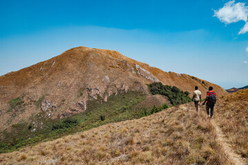 Rear view of a hiker against a mountain background at Mbeya Paek, Tanzania