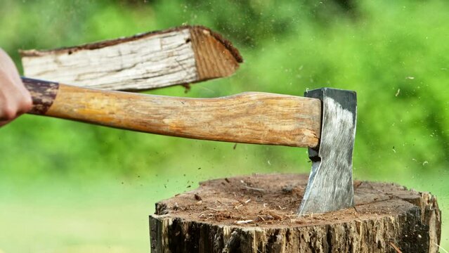 Super slow motion of chopping wooden logs with axe. Filmed on high speed cinema camera, 1000 fps. Speed ramp effect.