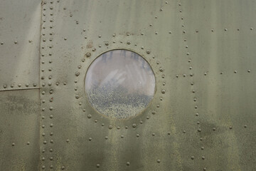 Details of the fuselage of an old aircraft. Old camouflage surface on a military aircraft 