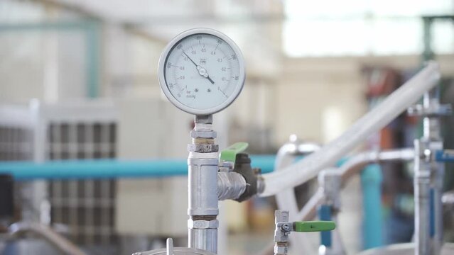 Worker starts Industrial Machine Pressure Gauge runs