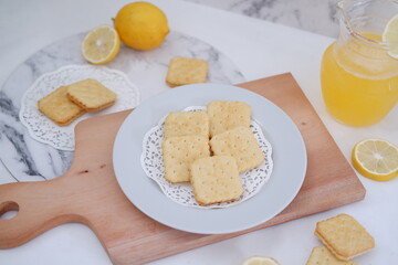 Crispy crackers and lemon juice on a white background.