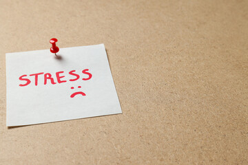 Paper with word Stress on beige background, space for text