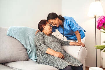 Portrait of young Asian nurse with elderly woman. Helpful volunteer taking care of senior lady at healthcare home. Picture of a senior lady with her friendly caregiver.