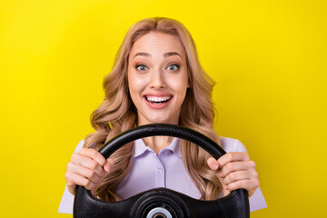 Photo of pretty excited lady wear purple polo enjoying riding car isolated yellow color background