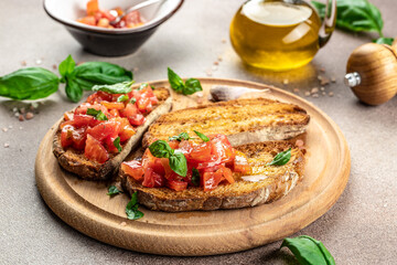 Bruschetta with tomatoes and basil on a cutting board. Traditional italian appetizer or snack, Healthy food concept. place for text, top view
