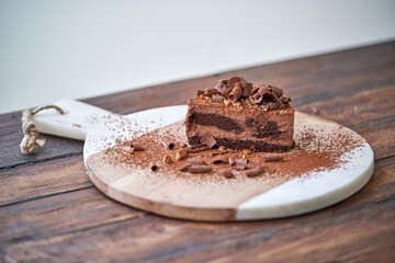 Piece of delicious chocolate cake on board
