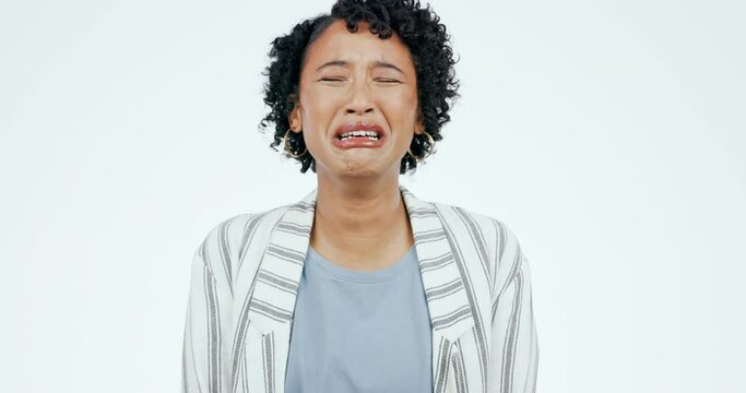 Depression, crying and face of sad woman in studio with anxiety, fear or mental health crisis on white background. Tears, portrait and lady model with stress, grief or broken heart, loss or mourning