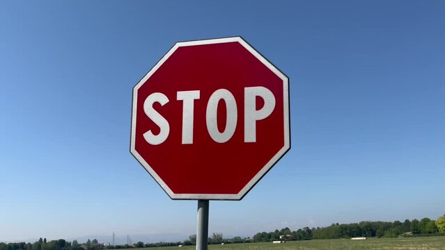 Stop signal in full sun with blue sky. Concept for prohibition, danger, forbidden, depression, protection, bad habits, nostalgia, problem, solitude,advice, control, warning, caution, safety, war, poll