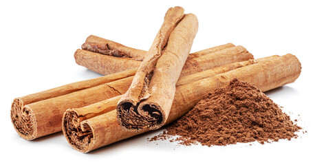 Cinnamon dried bark strips and cinnamon powder, sweet-smelling brown substance used in cooking, isolated on white background.