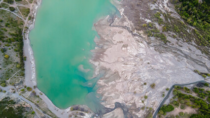 A mountain lake shore eroded by a mudflow