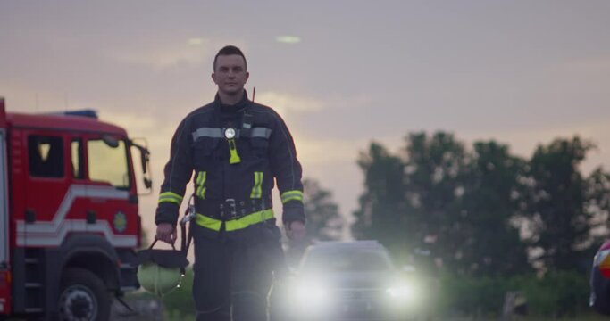 Close-up portrait of a heroic fireman in a protective suit. Firefighter in fire fighting operation.