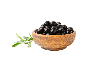Tasty black olives in a wooden bowl with leaves isolated on a white background. Vegan. Design.
