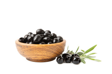 Tasty black olives in a wooden bowl with leaves isolated on a white background. Vegan. Design.