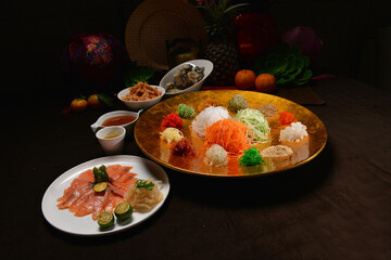 fresh colourful asian festive vegetables salad lo hei yu sheng with smoked salmon, fish skin,...