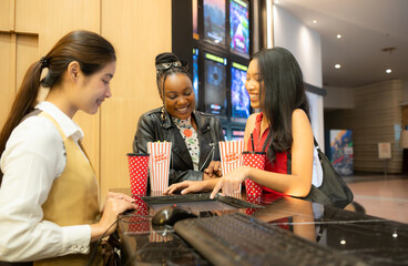 Asian ticket seller at the box office with the service of selling movie tickets to movie audiences...