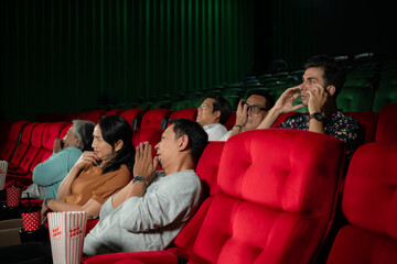 When watching scary ghost movies in theaters, moviegoers appear terrified.
