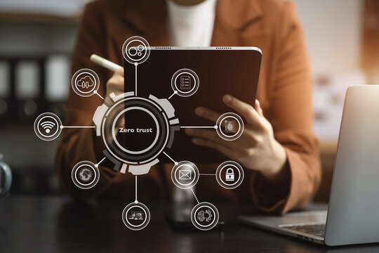 Zero trust security concept Person using smartphone and tablet with zero trust icon on virtual screen of Data businesses.in office.