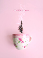 Creative layout made of pink floral coffee cup and smoke made of coffee beans with COFFEE and CHILL message against pastel pink background. Flat lay, copy space. Morning routine. Girly essentials. 