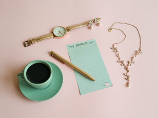 Creative layout made of mint coffee cup, rose gold watch, earrings, necklace, shopping list and pink pen against pastel pink background. Girl essentials. Coffee time. Flat lay, copy space. - Powered by Adobe