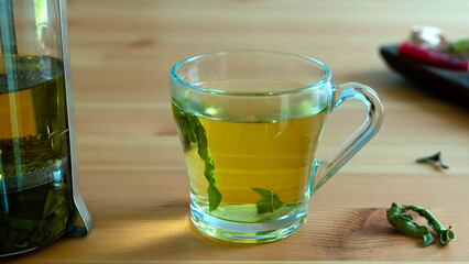 green tea mug over wooden table