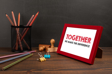 TOGETHER WE MAKE THE DIFFERENCE. A picture frame on the office table