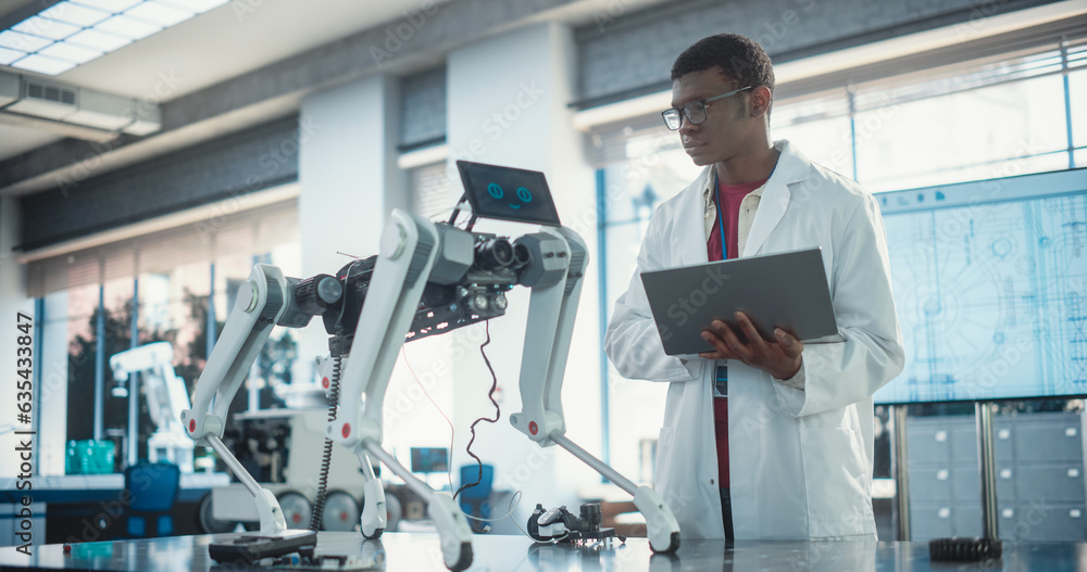 Aufkleber young african american male engineer testing industrial programmable robot animal in a factory devel